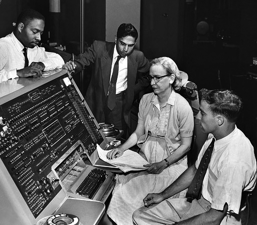 Grace Hopper at a UNIVAC keyboard with colleagues from the Automatic Programming Department in 1957